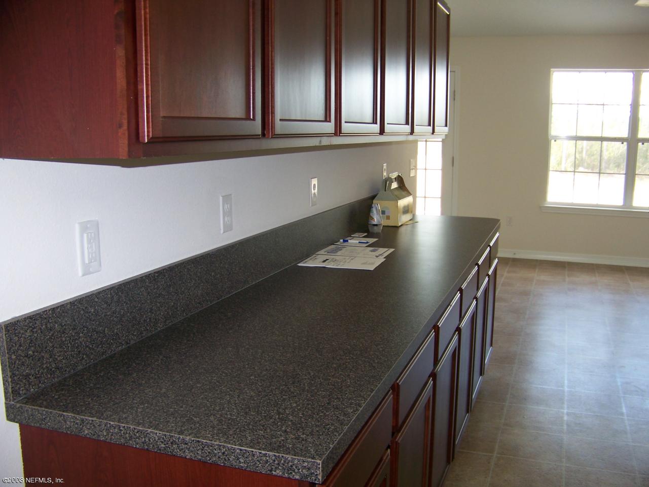 3099 Longleaf Ranch Circle Middleburg, FL 32068 - Photo 3 of 4 kitchen with cherry wood cabinets