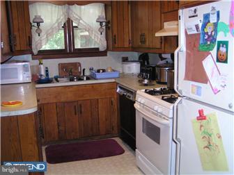 245 Holly Road Clayton, NJ 08094 - Photo 3 of 8 a kitchen with stainless steel appliances a stove a microwave and cabinets
