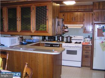 245 Holly Road Clayton, NJ 08094 - Photo 4 of 8 a kitchen with kitchen island granite countertop a sink and a stove