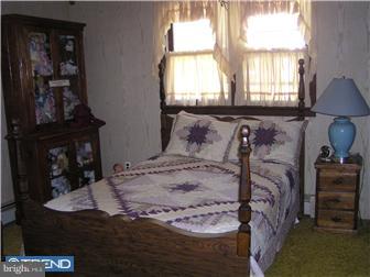 245 Holly Road Clayton, NJ 08094 - Photo 5 of 8 a bed sitting in a bedroom next to a window
