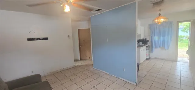 an empty room with entrance and windows