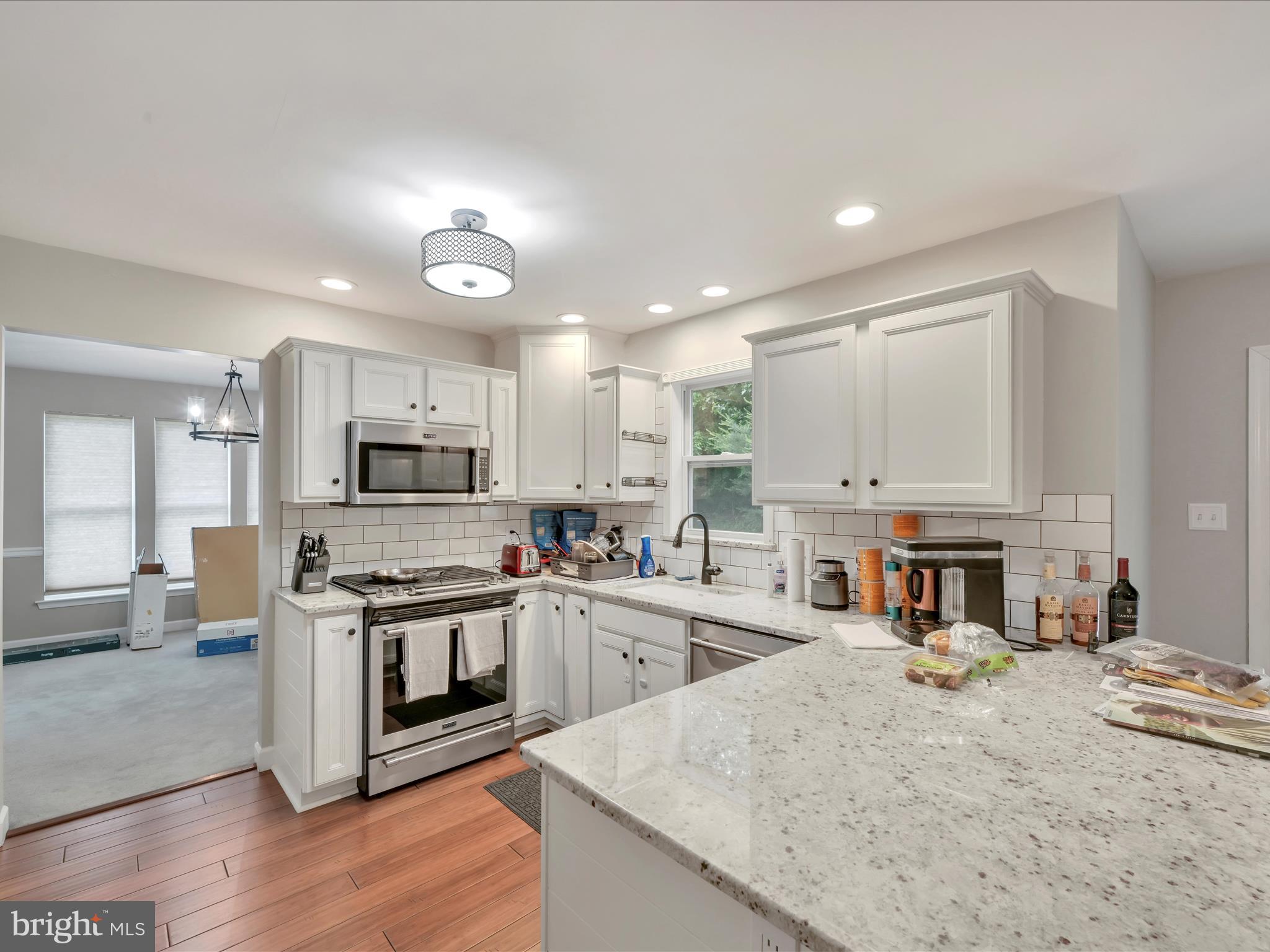 15 Country Club Road Ashland, PA 17921 - Photo 14 of 39 a kitchen with stainless steel appliances granite countertop a stove top oven a sink dishwasher and a refrigerator with wooden floor