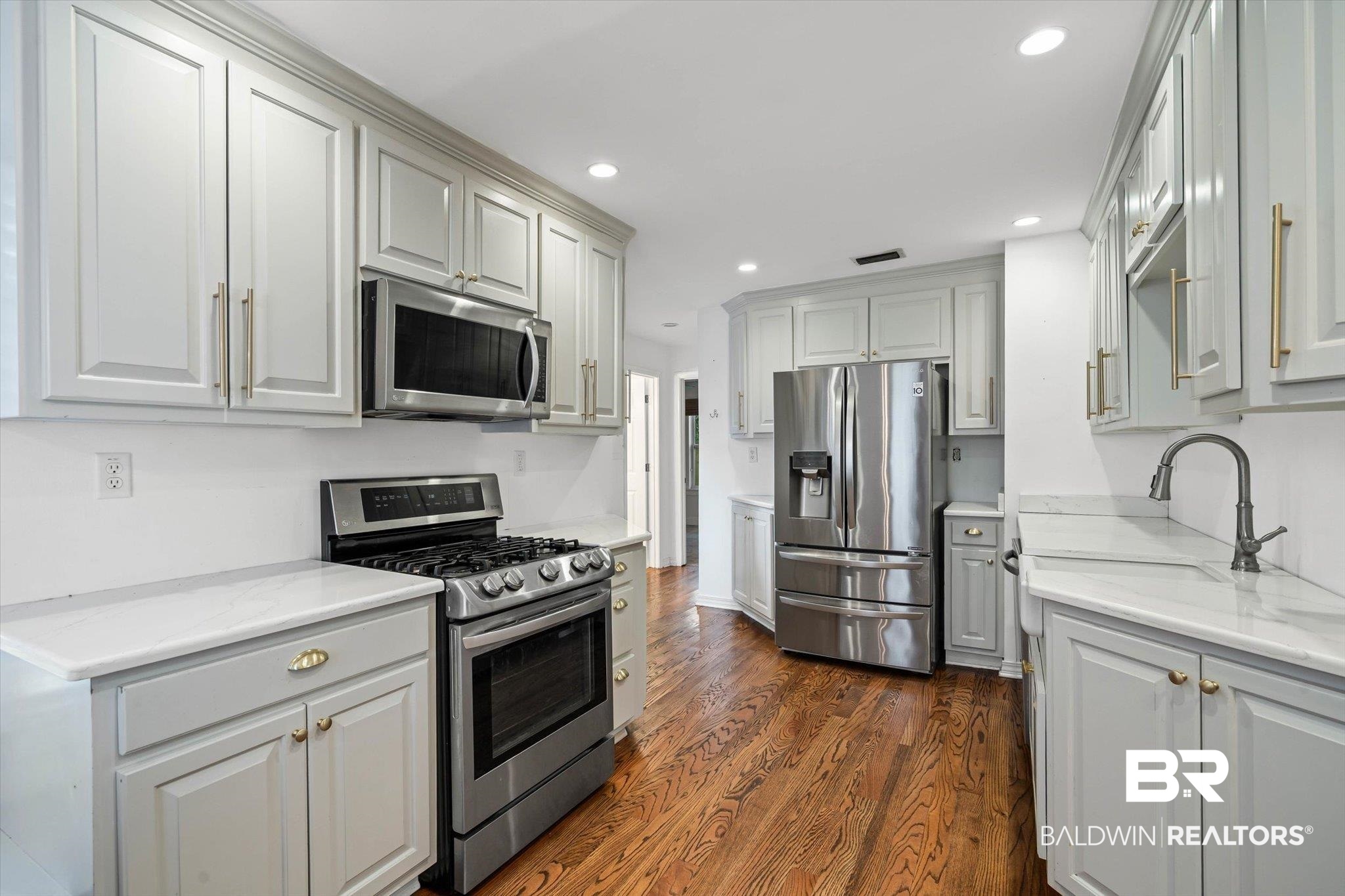 11 York Place Mobile, AL 36608 - Photo 10 of 24 Kitchen with appliances with stainless steel finishes, dark wood-style floors, recessed lighting, light stone counters, and gray cabinetry