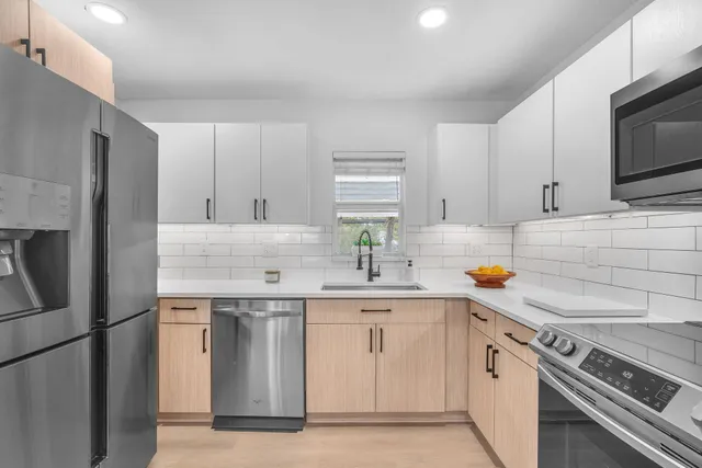 a kitchen with a sink stove and refrigerator