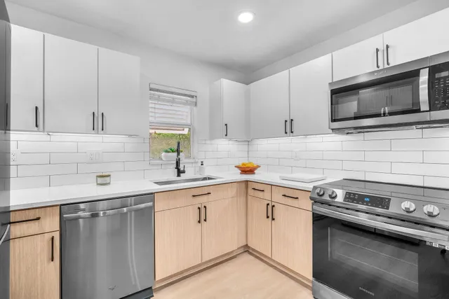 a kitchen with a sink stove and microwave