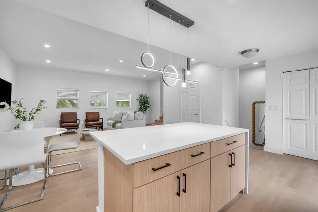 a large kitchen with a table chairs and a chandelier