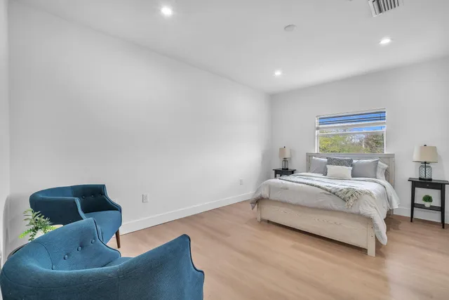 a bed room with a bed and a chair