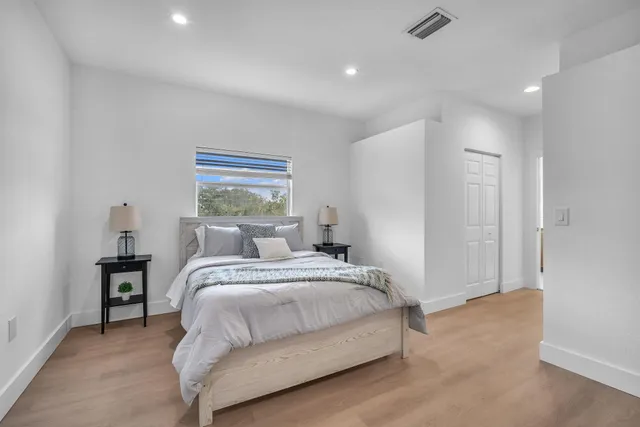 a bedroom with a bed and a window