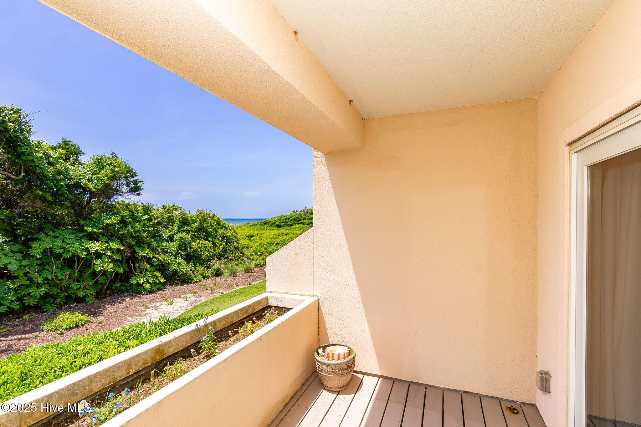331 Salter Path Road, Unit 104 BEACHWALK Pine Knoll Shores, NC 28512 - Photo 5 of 47 Patio access from living room and primary suite