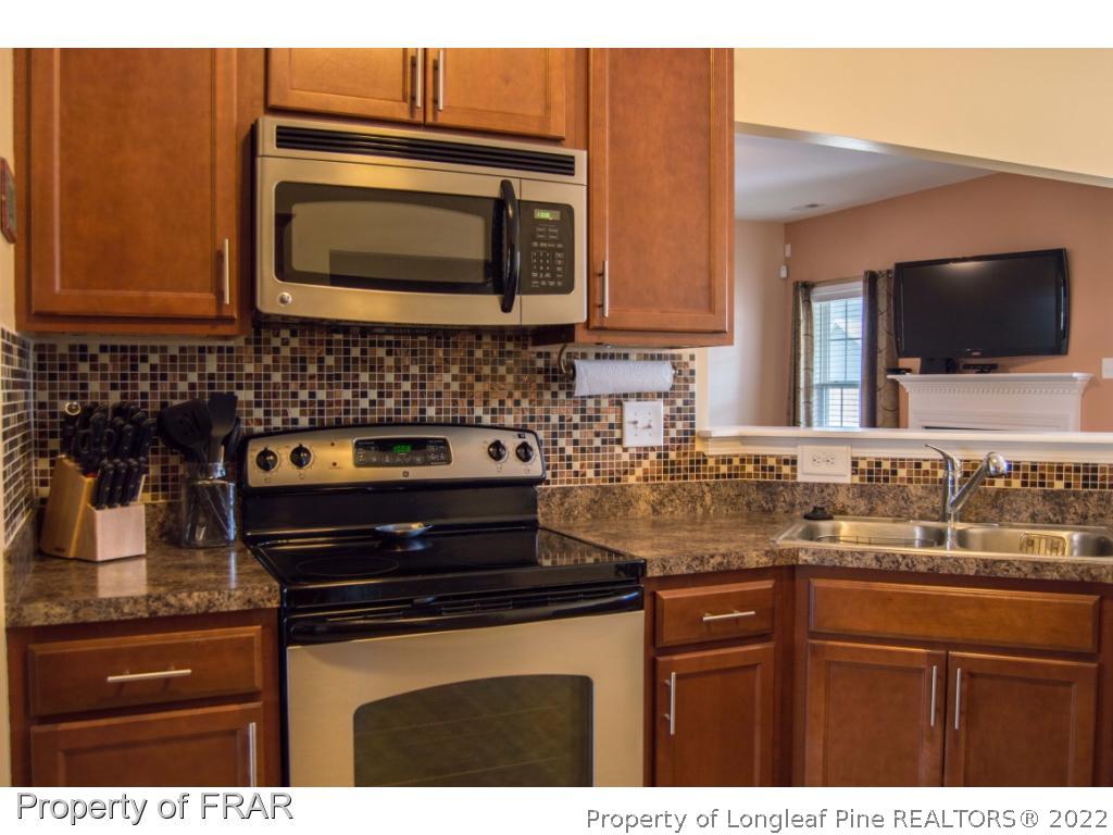 1444 Rough Rider Lane Parkton, NC 28371 - Photo 12 of 36 a kitchen with a sink and a microwave