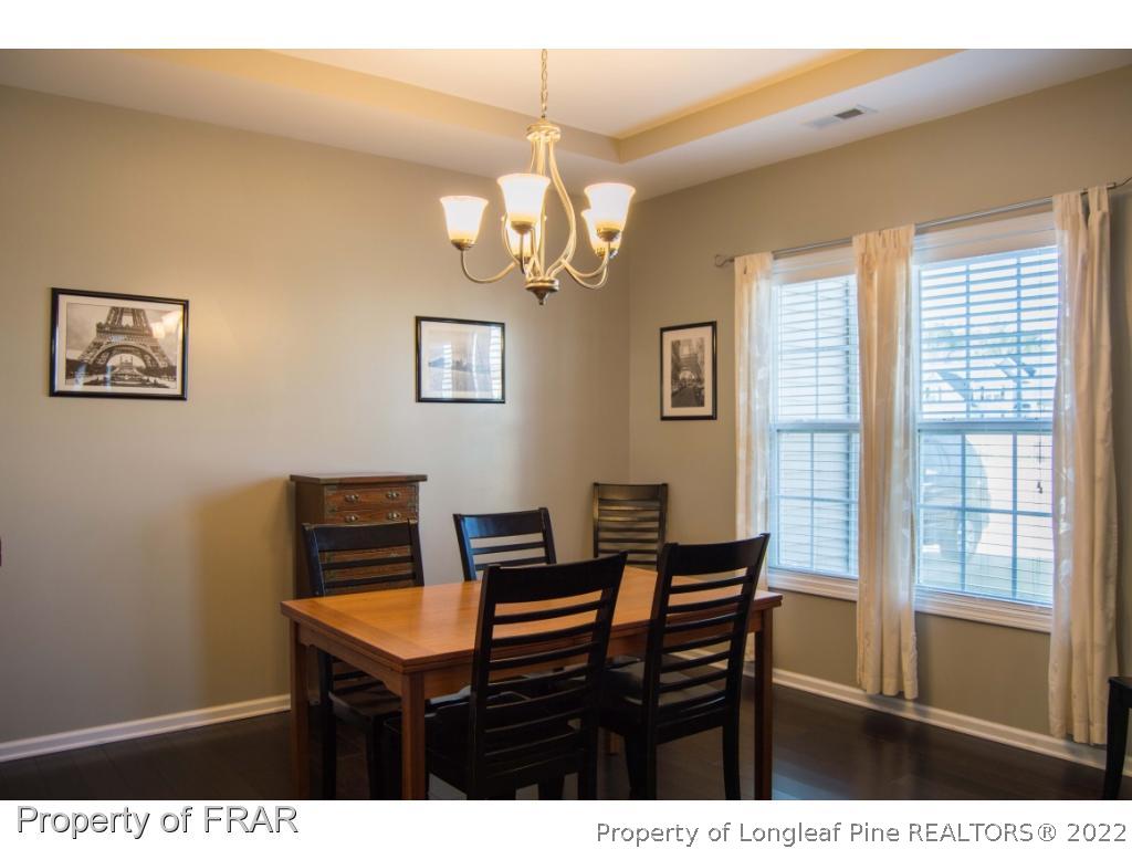 1444 Rough Rider Lane Parkton, NC 28371 - Photo 17 of 36 a view of a dining room with furniture a chandelier and a window