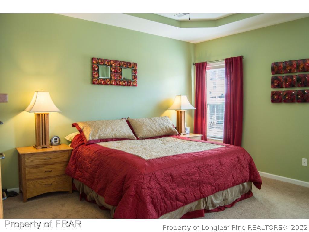 1444 Rough Rider Lane Parkton, NC 28371 - Photo 19 of 36 a bedroom with a bed and wooden floor
