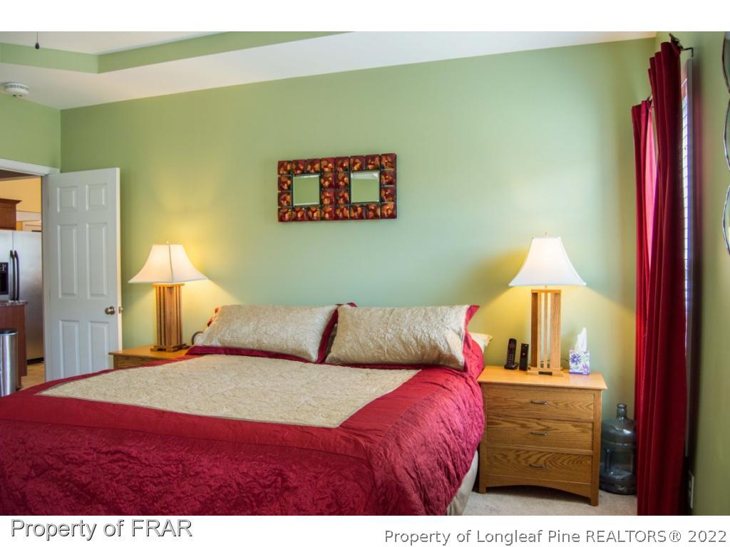 1444 Rough Rider Lane Parkton, NC 28371 - Photo 20 of 36 a bedroom with a bed and a night stand