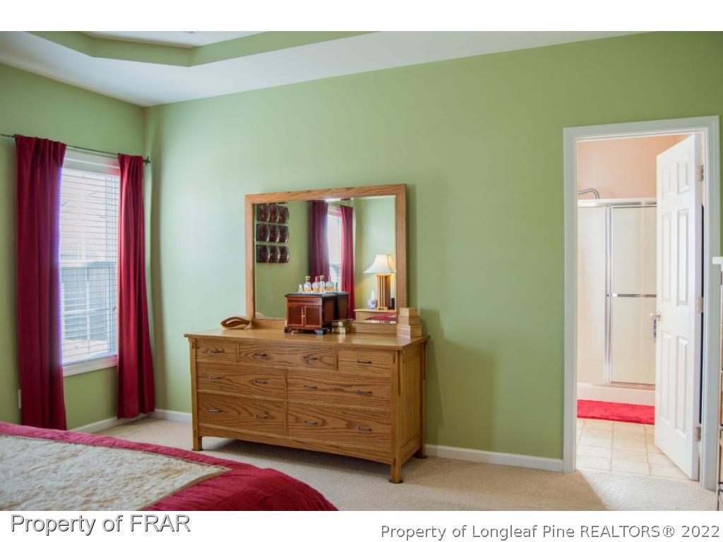 1444 Rough Rider Lane Parkton, NC 28371 - Photo 21 of 36 a living room with a furniture and a dresser