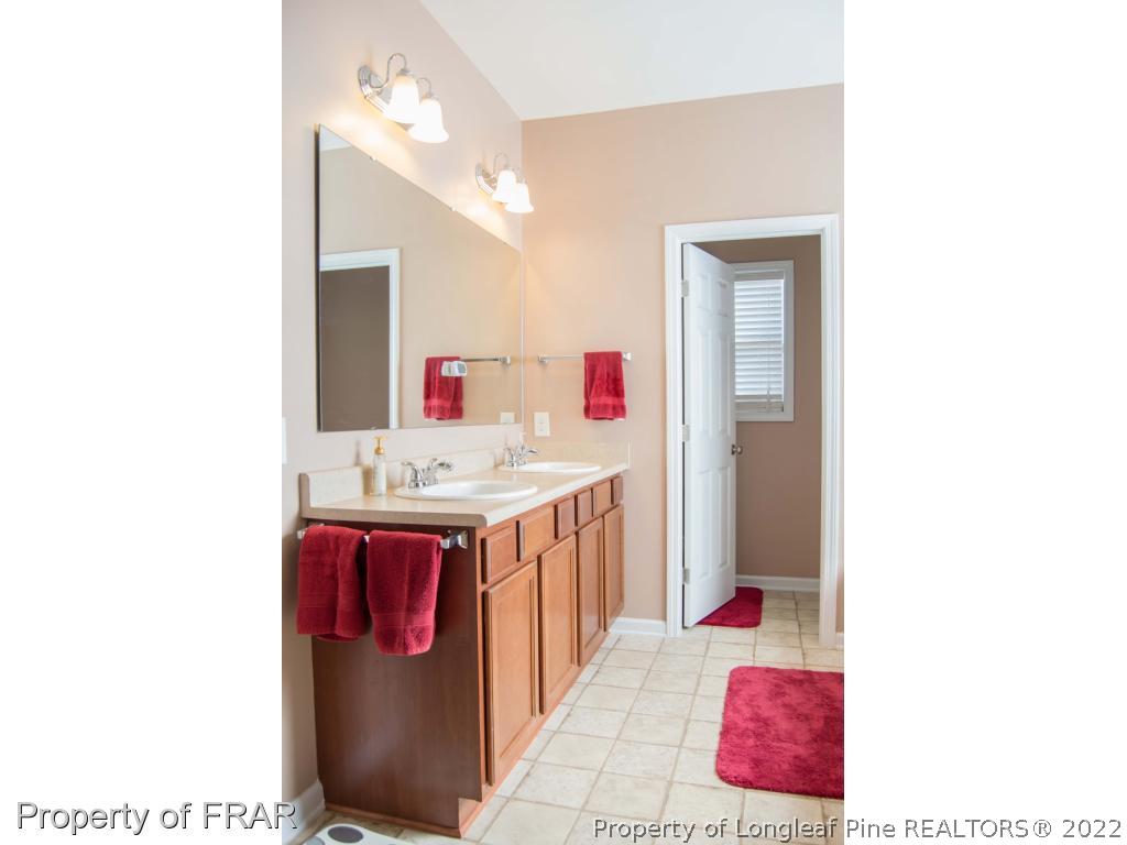 1444 Rough Rider Lane Parkton, NC 28371 - Photo 22 of 36 a bathroom with a sink vanity and a mirror