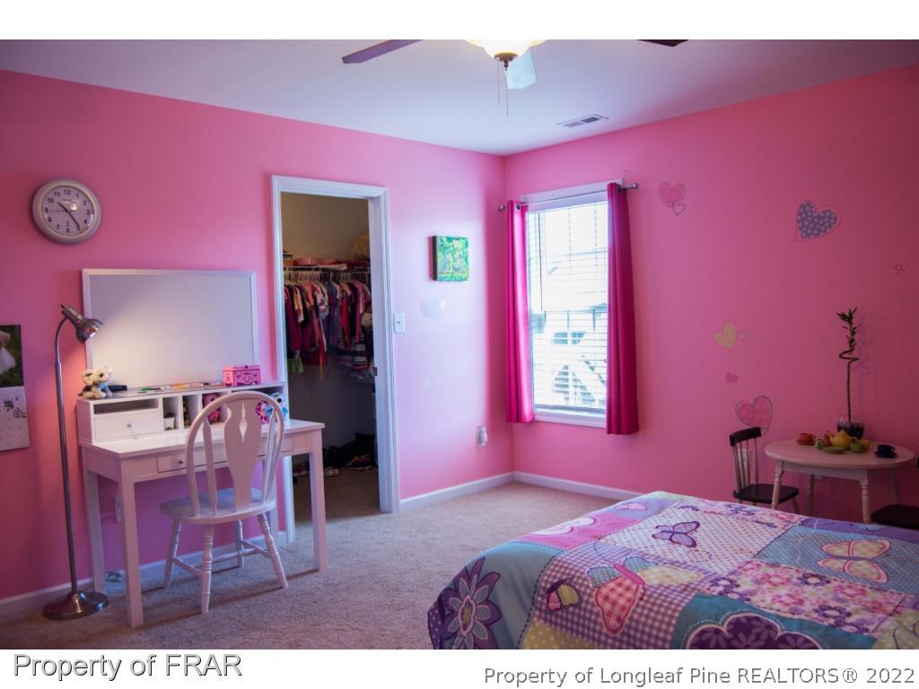 1444 Rough Rider Lane Parkton, NC 28371 - Photo 27 of 36 a bedroom with a bed and a dresser