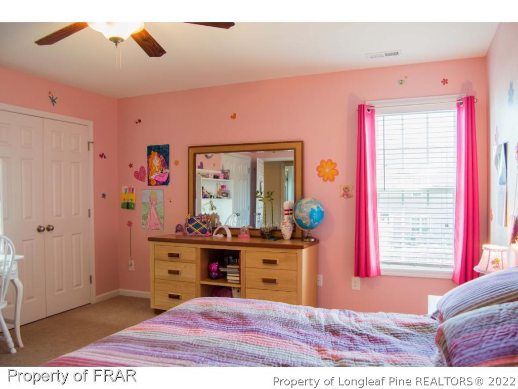 1444 Rough Rider Lane Parkton, NC 28371 - Photo 29 of 36 a view of a bedroom with furniture and windows