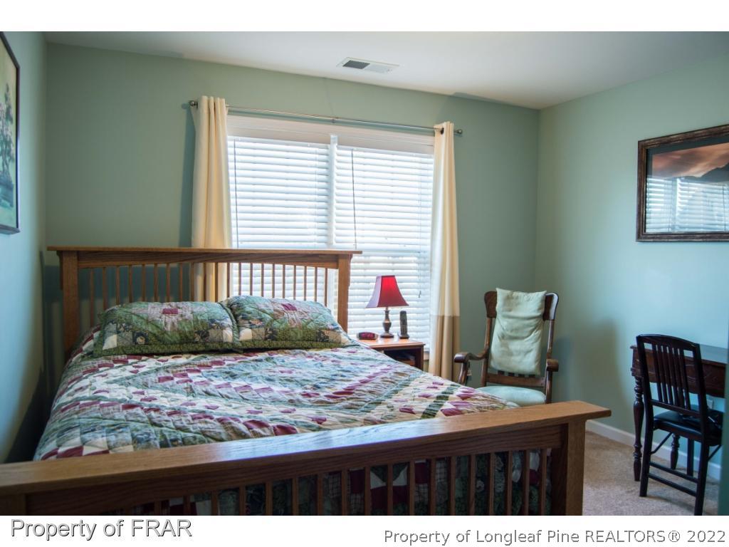 1444 Rough Rider Lane Parkton, NC 28371 - Photo 31 of 36 a bedroom with a bed and window