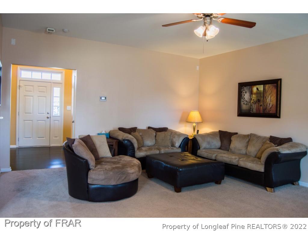 1444 Rough Rider Lane Parkton, NC 28371 - Photo 5 of 36 a living room with furniture and a lamp