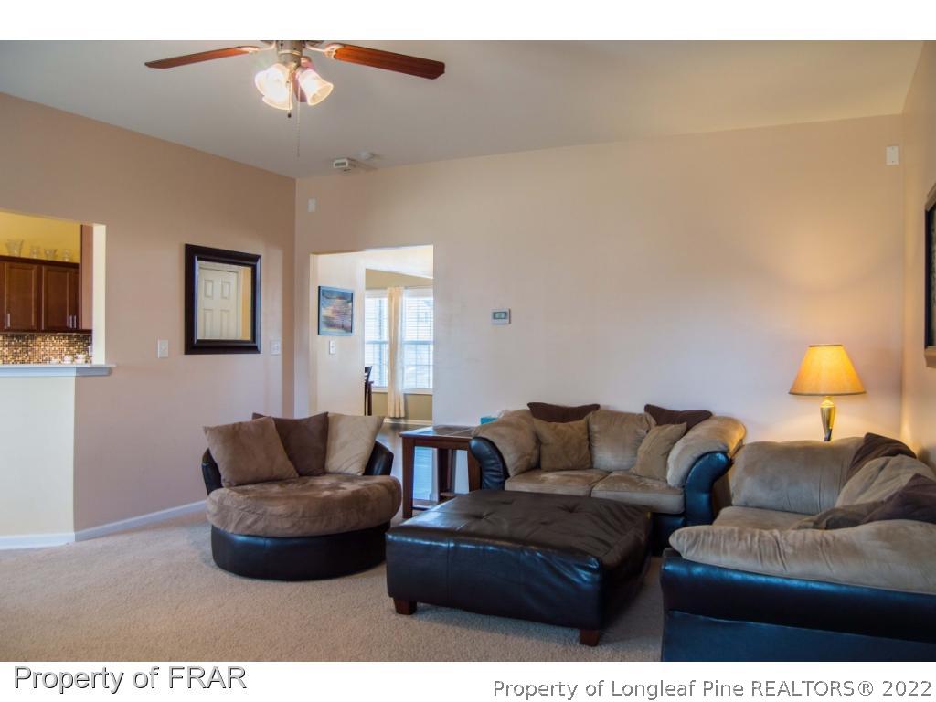 1444 Rough Rider Lane Parkton, NC 28371 - Photo 6 of 36 a living room with furniture and a flat screen tv