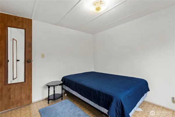 a bedroom with a bed and a table in it