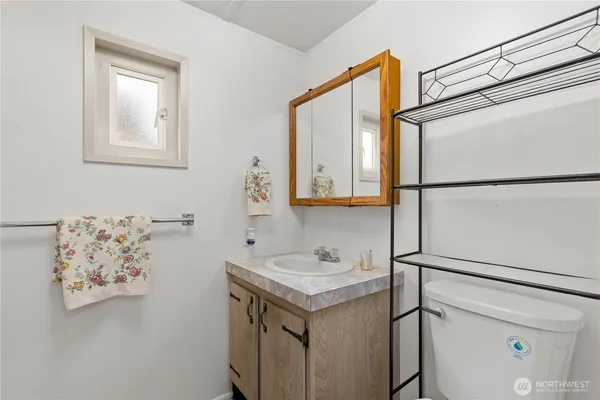 a bathroom with a sink and a refrigerator