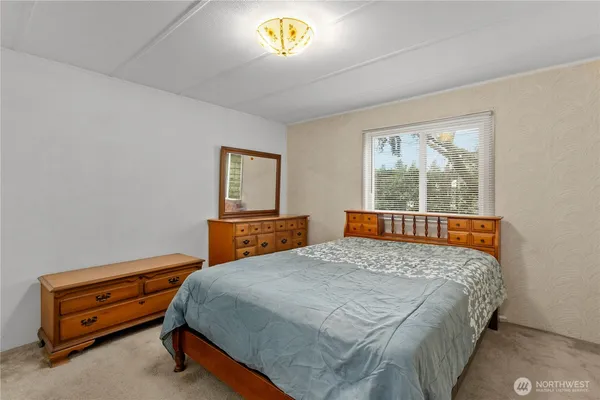 a bedroom with a bed and a window