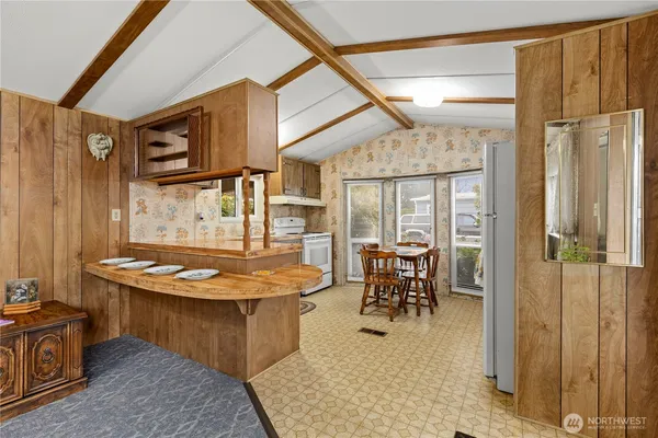 a dining room with furniture a window and stainless steel appliances