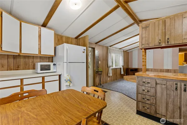 a kitchen with a refrigerator and a stove top oven