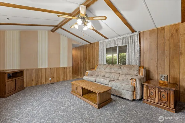 a living room with furniture and a chandelier