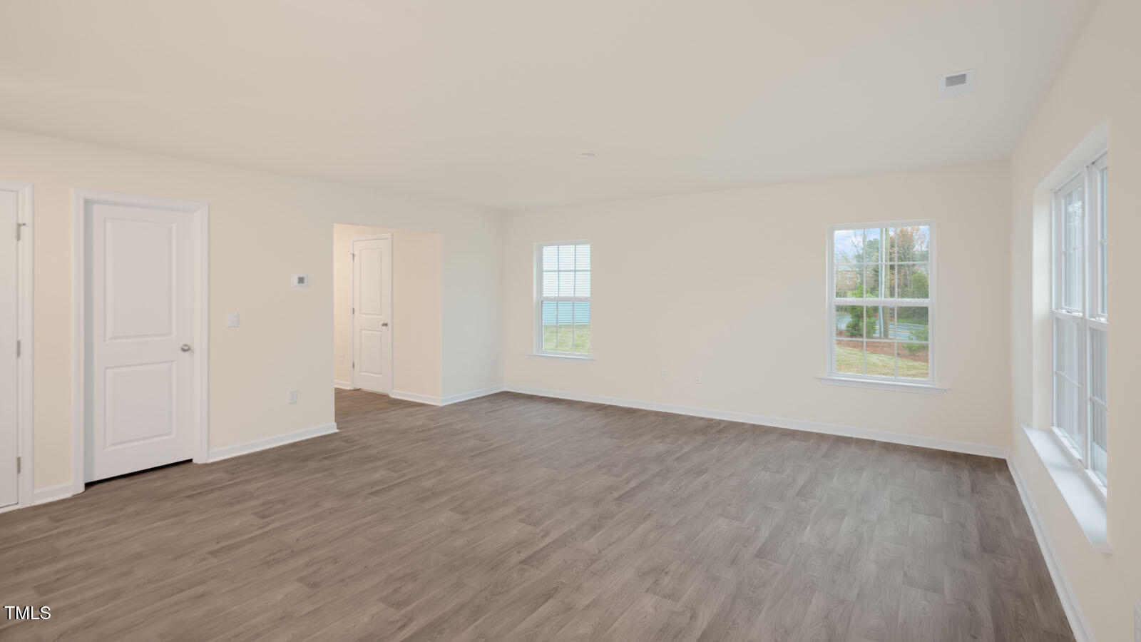 3604 Sorda Court Raleigh, NC 27610 - Photo 9 of 25 an empty room with wooden floor and windows