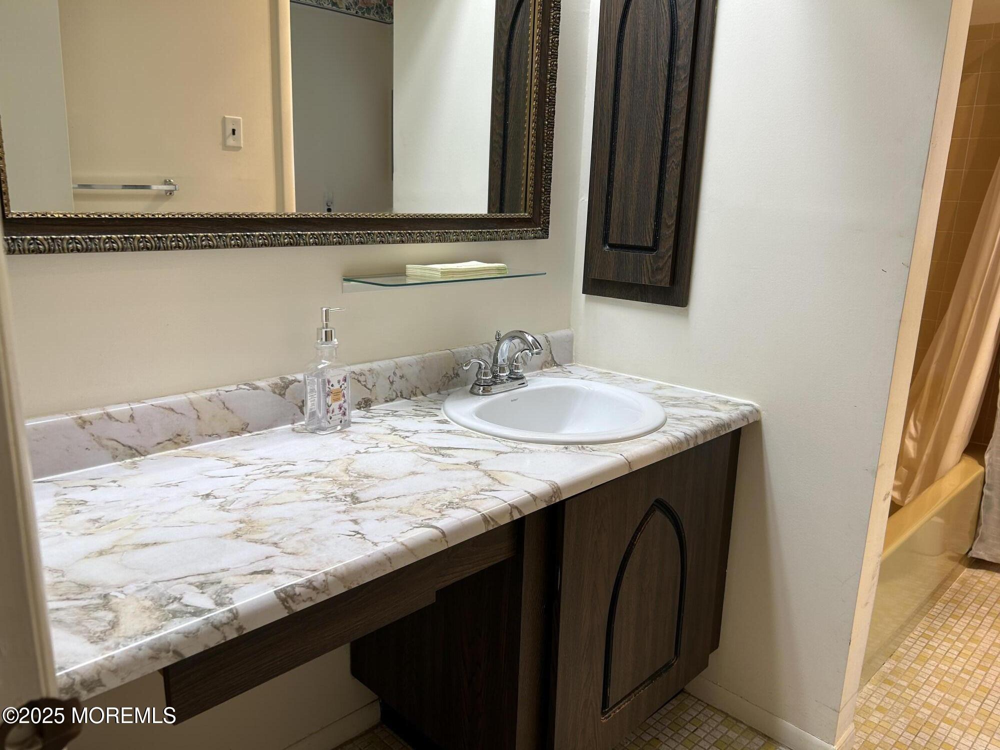 5 Lamb Road Brick, NJ 08724 - Photo 15 of 38 a bathroom with a granite countertop sink and a mirror