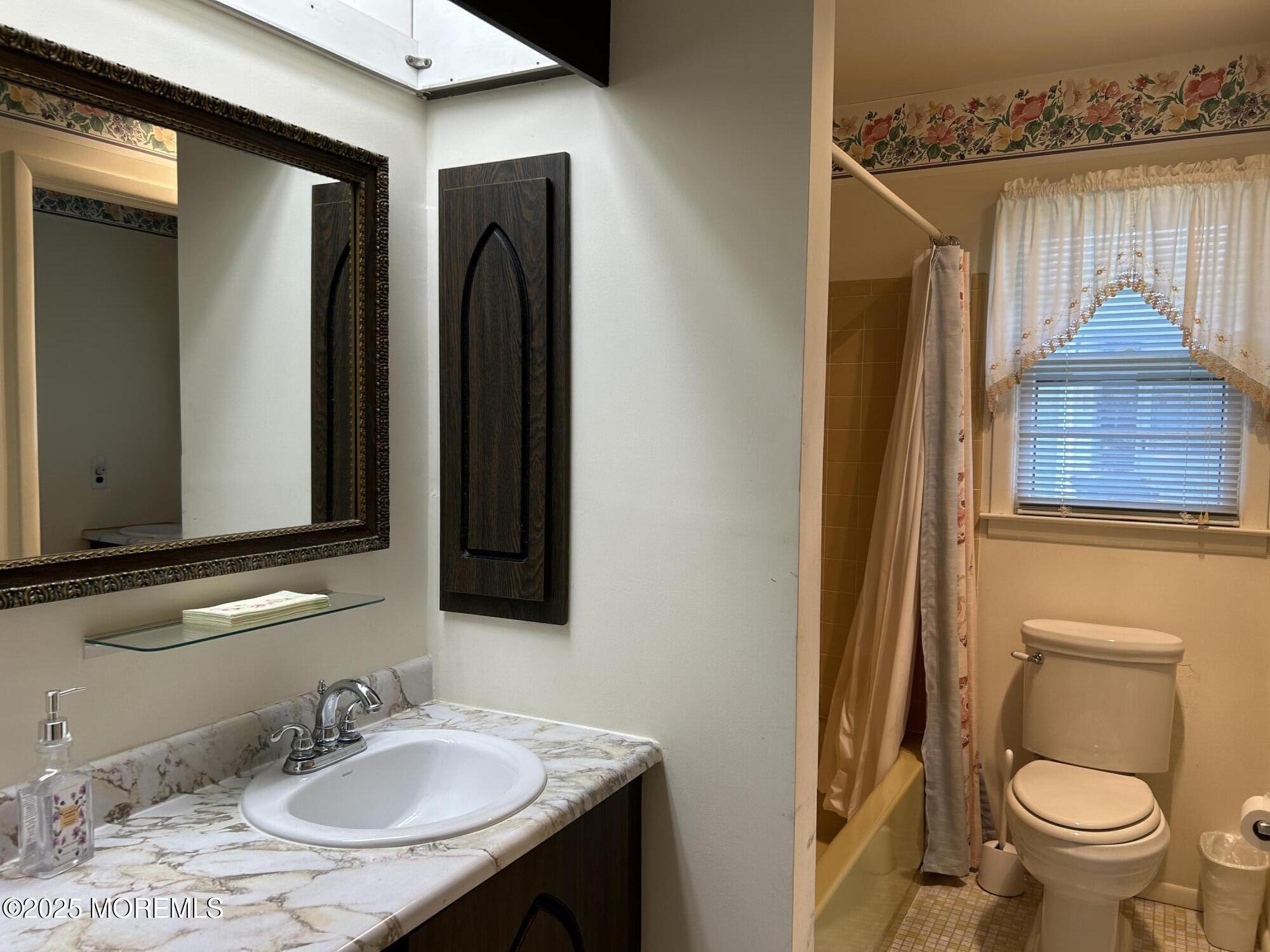 5 Lamb Road Brick, NJ 08724 - Photo 16 of 38 a bathroom with a granite countertop sink toilet and a mirror