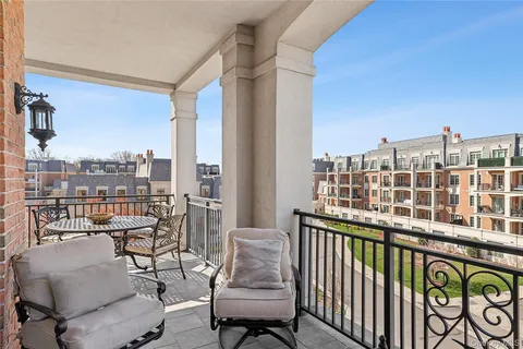 a view of a balcony with a chairs