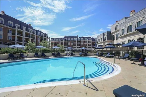 a swimming pool with outdoor seating and yard