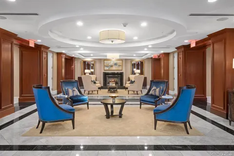 a living room with furniture a rug and a chandelier