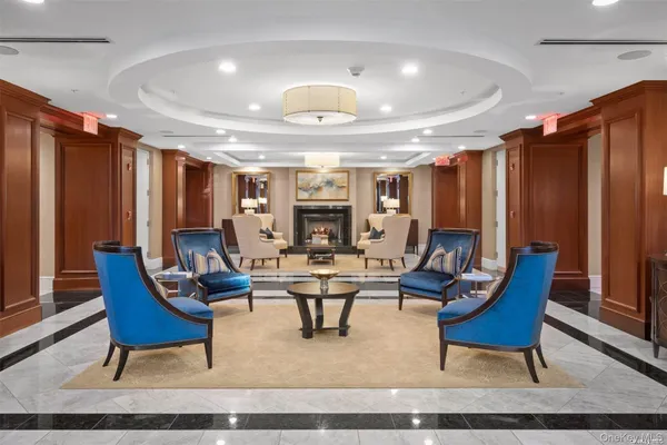 a living room with furniture a rug and a chandelier