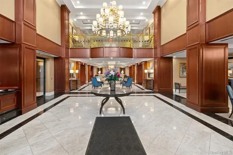a view of lobby with a couch and chandelier