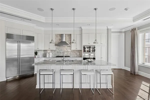 a kitchen with center island and stainless steel appliances