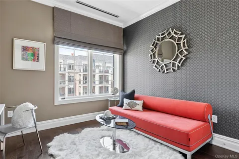 a living room with furniture a rug and a window