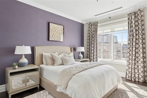 a bedroom with bed and a window