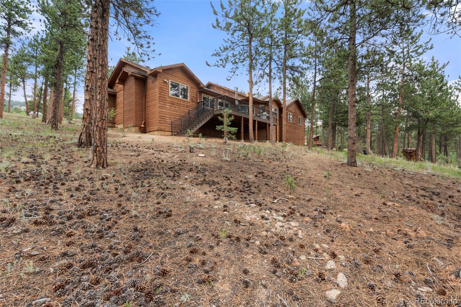 84 Marys Lane Bailey, CO 80421 - Photo 28 of 35 a front view of a house with a yard