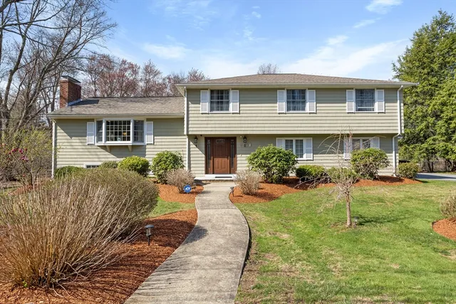 a view of a house with backyard sitting area and garden