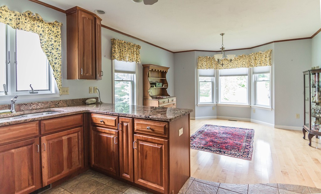 122 Rice Corner Road Brookfield, MA 01506 - Photo 3 of 29 a kitchen with stainless steel appliances granite countertop wooden cabinets a sink and a window