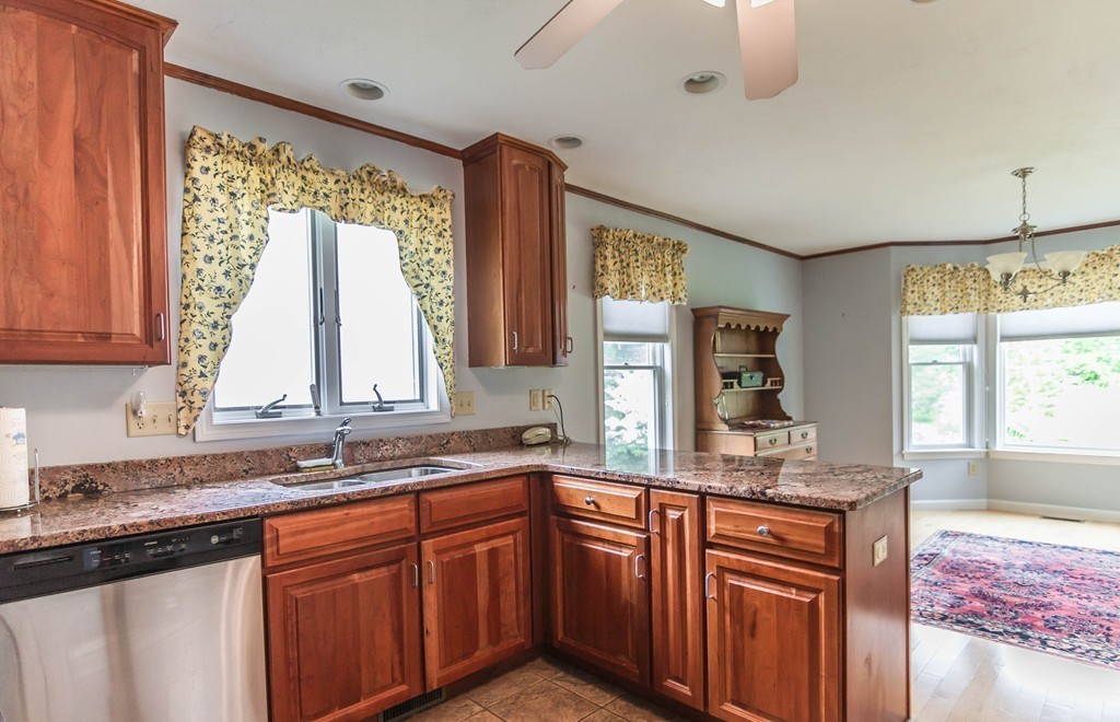 122 Rice Corner Road Brookfield, MA 01506 - Photo 4 of 29 a kitchen with stainless steel appliances granite countertop a sink a stove and a wooden cabinets