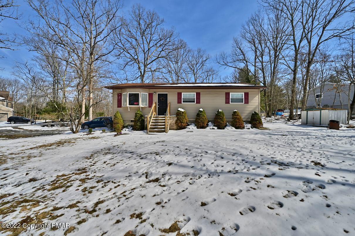 1039 Dancing Ridge Road East Stroudsburg, PA 18302 - Photo 1 of 40 a front view of a house with a yard covered in snow