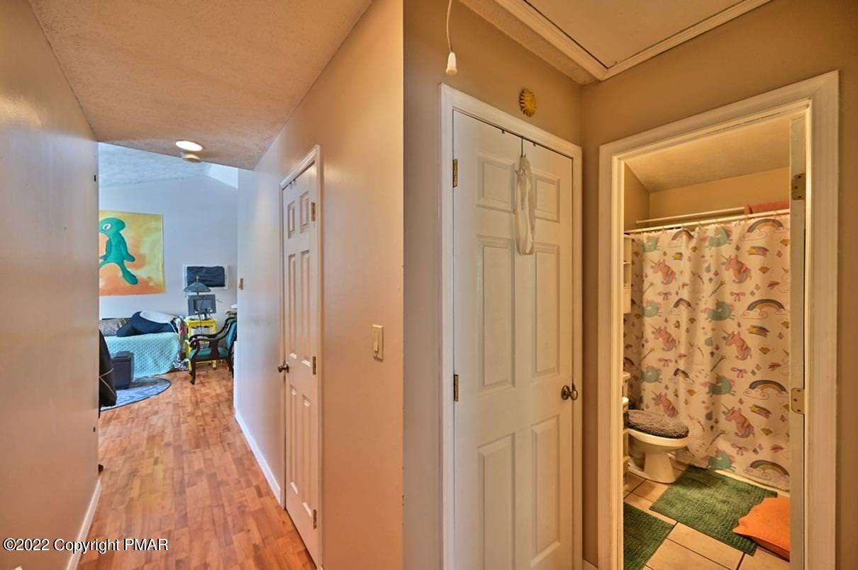 1039 Dancing Ridge Road East Stroudsburg, PA 18302 - Photo 23 of 40 a view of a hallway with bathroom and wooden floor