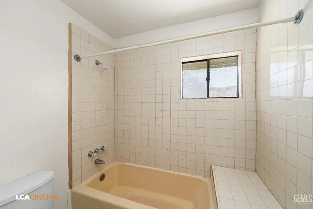 a bathroom with a bathtub and shower