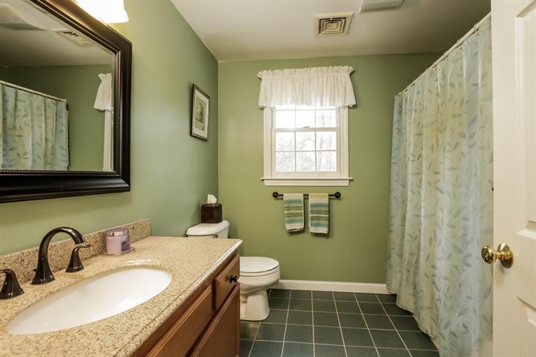 7 Whitecliff Road Buzzards Bay, MA 02532 - Photo 3 of 21 a bathroom with a granite countertop sink a mirror a toilet and a window