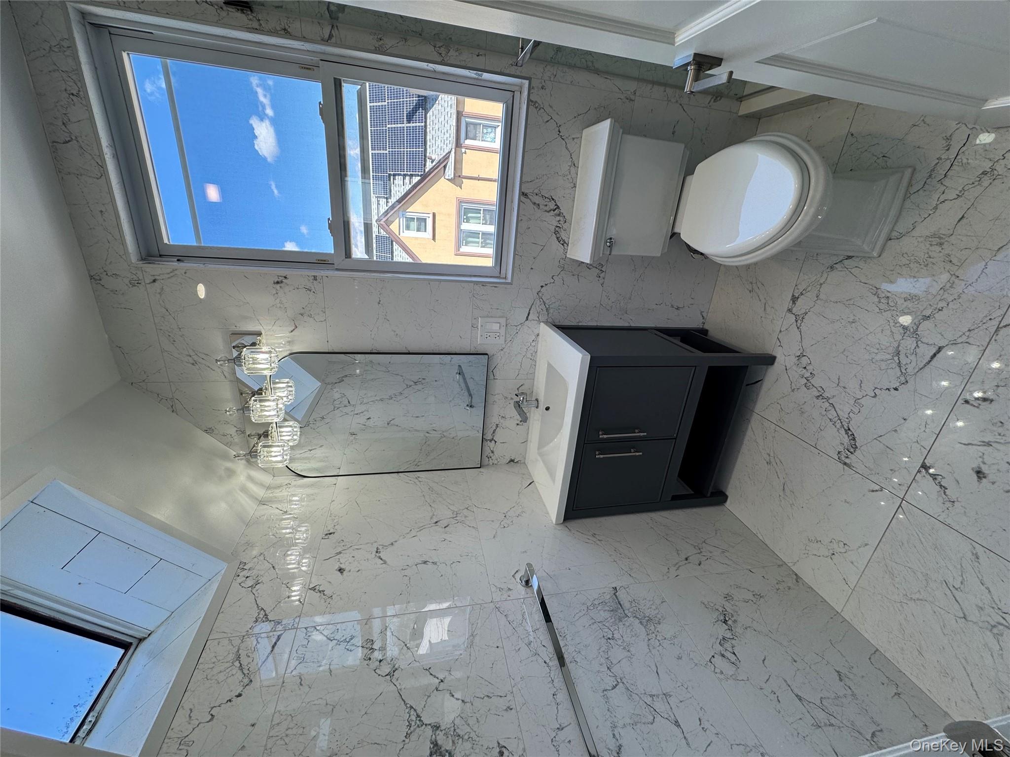 88-36 77th Street Queens, NY 11421 - Photo 17 of 19 a bathroom with a sink toilet a mirror and bathtub